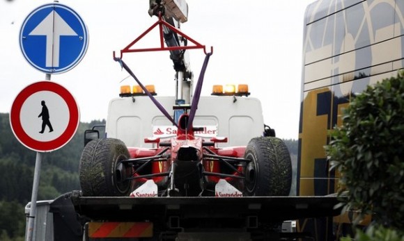 A truck lifts the crashed car of Ferrari