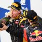 SAKHIR, BAHRAIN - APRIL 22:  Race winner Sebastian Vettel (R) of Germany and Red Bull Racing celebrates on the podium with second placed Kimi Raikkonen (L) of Finland and Lotus following the Bahrain Formula One Grand Prix at the Bahrain International Circuit on April 22, 2012 in Sakhir, Bahrain.  (Photo by Mark Thompson/Getty Images)