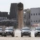 Four Volkswagens Amarok pull down a giant chimney