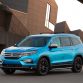 2016 Honda Pilot with accessories installed, including: 20-inch black wheels; chrome door mirror cover; chrome tailgate trim; running boards with lights; roof rails with crossbars; illuminated door sill trim; and chrome front bumper trim.