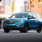2016 Honda Pilot with accessories installed, including: 20-inch black wheels; chrome door mirror cover; chrome tailgate trim; running boards with lights; roof rails with crossbars; illuminated door sill trim; and chrome front bumper trim.