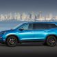 2016 Honda Pilot with accessories installed, including: 20-inch black wheels; chrome door mirror cover; chrome tailgate trim; running boards with lights; roof rails with crossbars; illuminated door sill trim; and chrome front bumper trim.