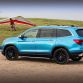 2016 Honda Pilot with accessories installed, including: 20-inch black wheels; chrome door mirror cover; chrome tailgate trim; running boards with lights; roof rails with crossbars; illuminated door sill trim; and chrome front bumper trim.