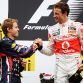 BUDAPEST, HUNGARY - JULY 31:  Race winner Jenson Button (R) of Great Britain and McLaren celebrates on the podium with second placed Sebastian Vettel (L) of Germany and Red Bull Racing following the Hungarian Formula One Grand Prix at the Hungaroring on July 31, 2011 in Budapest, Hungary.  (Photo by Mark Thompson/Getty Images)
