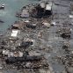 This aerial view taken on March 14, 2011 during an AFP-chartered flight shows an area destroyed by the tsunami in Minamisanriku in Miyagi prefecture three days after a massive 8.9 magnitude earthquake and tsunami devastated the coast of eastern Japan. A new explosion at a nuclear plant in nearby Fukushima prefecture hit punch-drunk Japan on March 14 as it raced to avert a reactor meltdown after a quake-tsunami disaster that is feared to have killed more than 10,000 people. AFP PHOTO / NOBORU HASHIMOTO (Photo credit should read NOBORU HASHIMOTO/AFP/Getty Images)