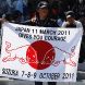 SUZUKA, JAPAN - OCTOBER 09:  Red Bull Racing fan holds up a banner in support of the victims of this years earthquake and tsunami before the Japanese Formula One Grand Prix at Suzuka Circuit on October 9, 2011 in Suzuka, Japan.  (Photo by Clive Rose/Getty Images)