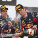 YEONGAM-GUN, SOUTH KOREA - OCTOBER 16:  Race winner Sebastian Vettel (L) of Germany and Red Bull Racing celebrates on the podium with third placed team mate Mark Webber of Australia and Red Bull Racing following the Korean Formula One Grand Prix at the Korea International Circuit on October 16, 2011 in Yeongam-gun, South Korea.  (Photo by Clive Mason/Getty Images)