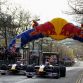 MILTON KEYNES, ENGLAND - DECEMBER 10:  Sebastian Vettel (R) of Germany and Red Bull Racing and Mark Webber (L) of Australia and Red Bull Racing drive thru the town streets while attending the Red Bull Racing Home Run event on December 10, 2011 in Milton Keynes, England.  (Photo by Mark Thompson/Getty Images for Red Bull)