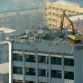 Taiyuan excavator working on top of 12 story building