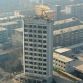 Taiyuan excavator working on top of 12 story building