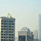 Taiyuan excavator working on top of 12 story building