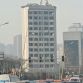 Taiyuan excavator working on top of 12 story building