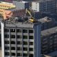 Taiyuan excavator working on top of 12 story building