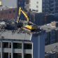 Taiyuan excavator working on top of 12 story building
