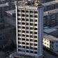 Taiyuan excavator working on top of 12 story building